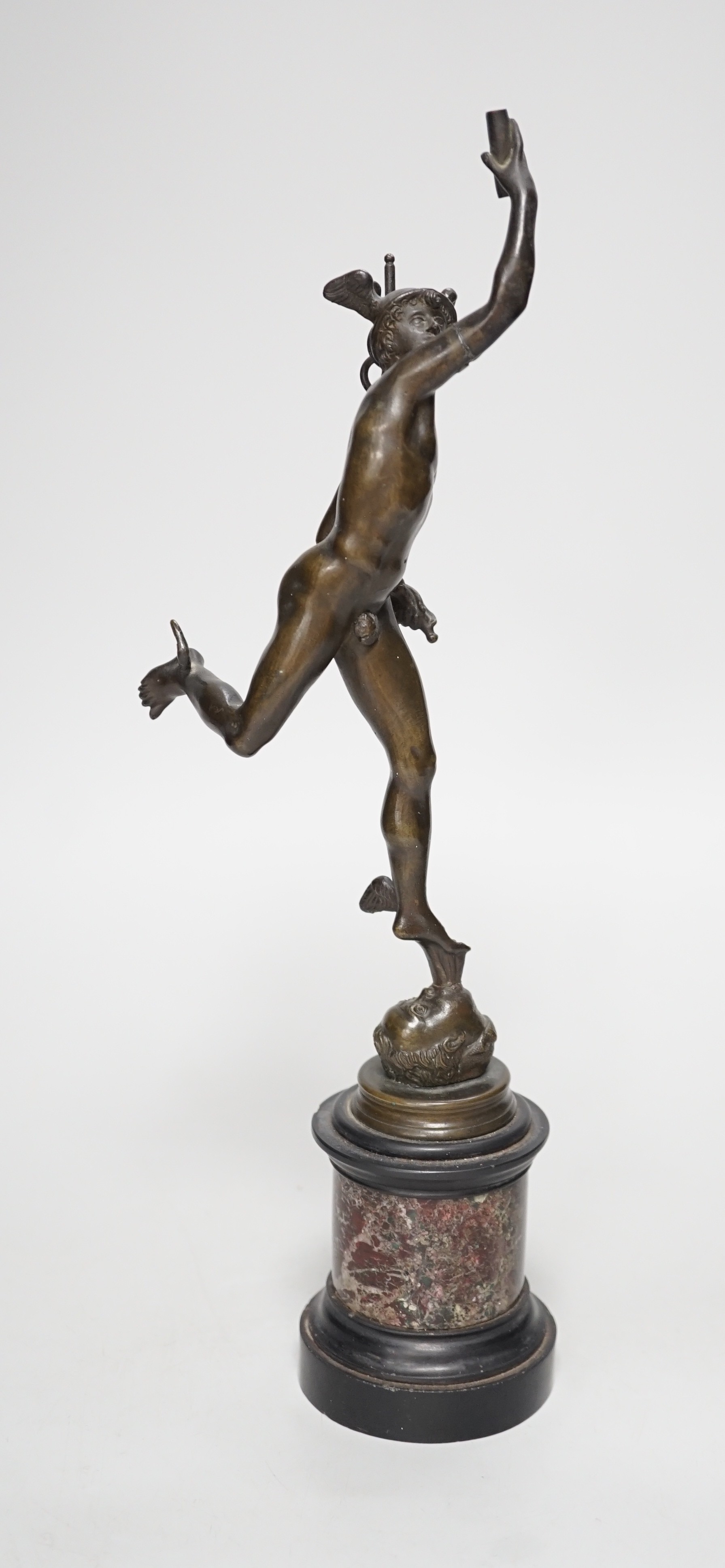 A bronze figure of Mercury on a graduated marble plinth. 33cm tall